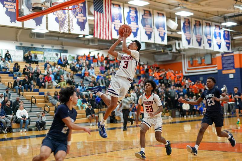 Oswego’s Ethan Vahl (3) drives to the hoop against Rockford Guilford during a hoops for healing basketball tournament game at Oswego on Monday, Nov. 25, 2024.