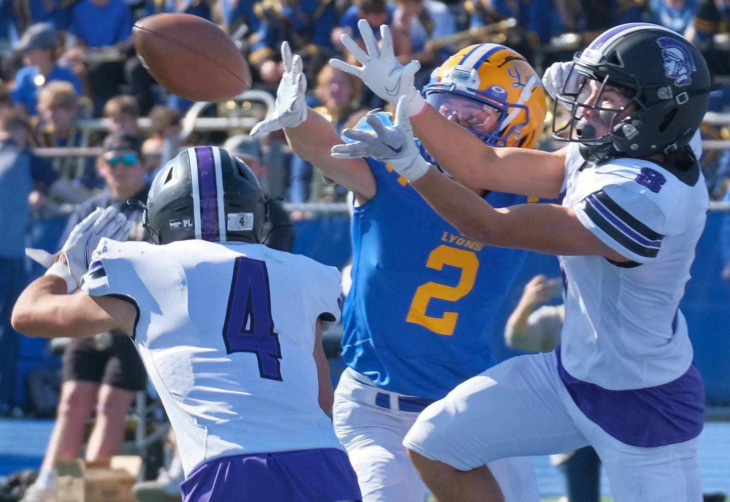 Lyons Township's Travis Stamm (2) and Downers Grove North's Jarett Henriquez and Joseph Chiarelli go for the ball during a game on Oct. 22, 2022 at Lyons Township High School in LaGrange.