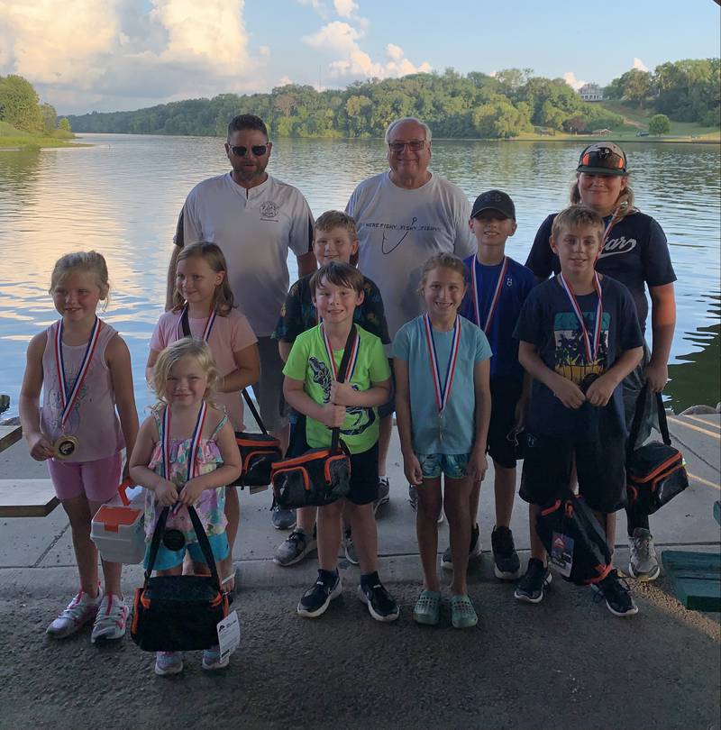 Commissioners James Less (back left) and Wayne Eichelkraut award prizes to (in no particular order) Anthony Varvaro, Lennon Knot, Hazel Crouch, Reagan Bernardoni, Cameron Countryman, Trenton Wawerski, Connor O’Flanigan, Beckham Sipula, Brandt Delmet and Lucy Crouch during the annual Kids Fishing Rodeo on Thursday, Aug. 4, 2022, in Ottawa.