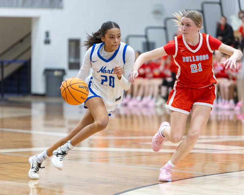 St. Charles North's Sydney Johnson drives the baseline against Batavia's Harper Haren on Friday, Dec.12,2025 in st. Charles.