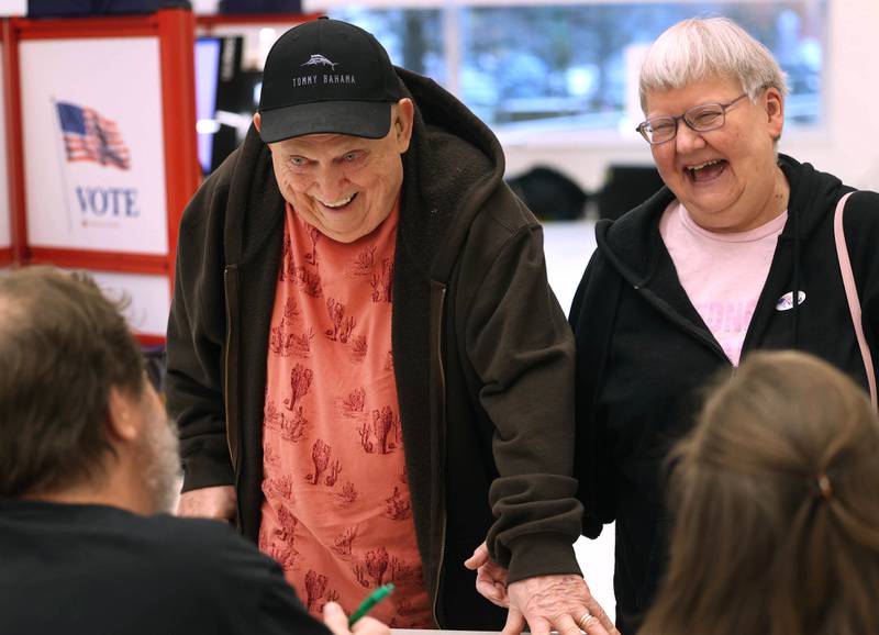 Karen Finnestad, from DeKalb, helps her husband Richard get checked in to vote Tuesday, Nov. 5, 2024, Election Day, at the DeKalb Public Library.