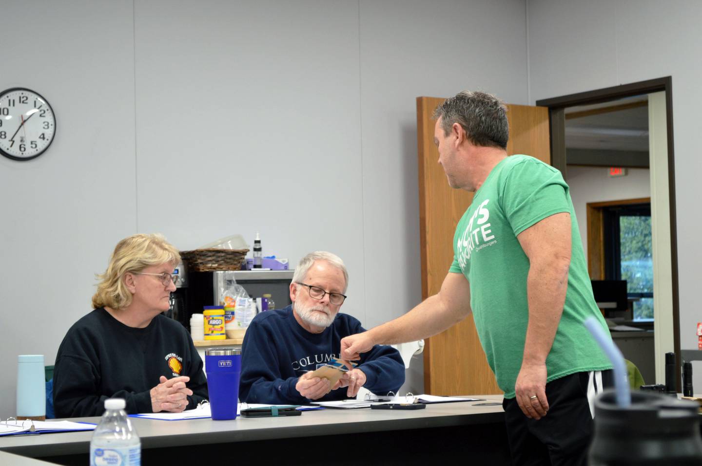 Detective Sgt. Doug Wolber (right) shows Hank and Violet Sobottka of Rock Falls, a paper bag used to store crime scene evidence during the April 3, 2024, meeting of the Rock Falls Police Department's Citizens Police Academy.