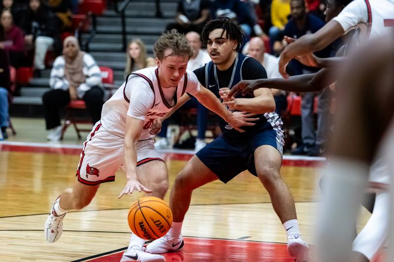 Bolingbrook's Trey Brost drives to the basket during a varsity boys basketball game against Oswego East at Bolingbrook on Dec. 12, 2025.