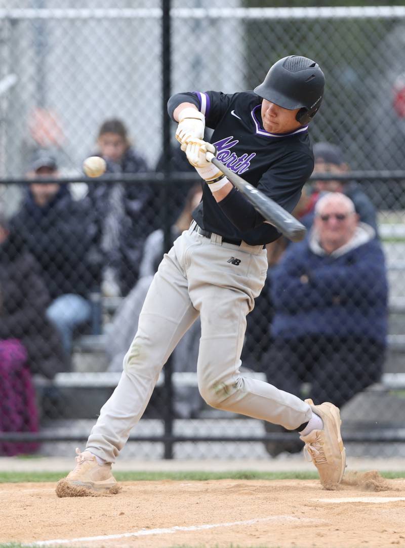 Downers Grove North's (25) makes contact during the varsity baseball game between Downers Grove South and Downers Grove North in Downers Grove on Saturday, April 29, 2023.