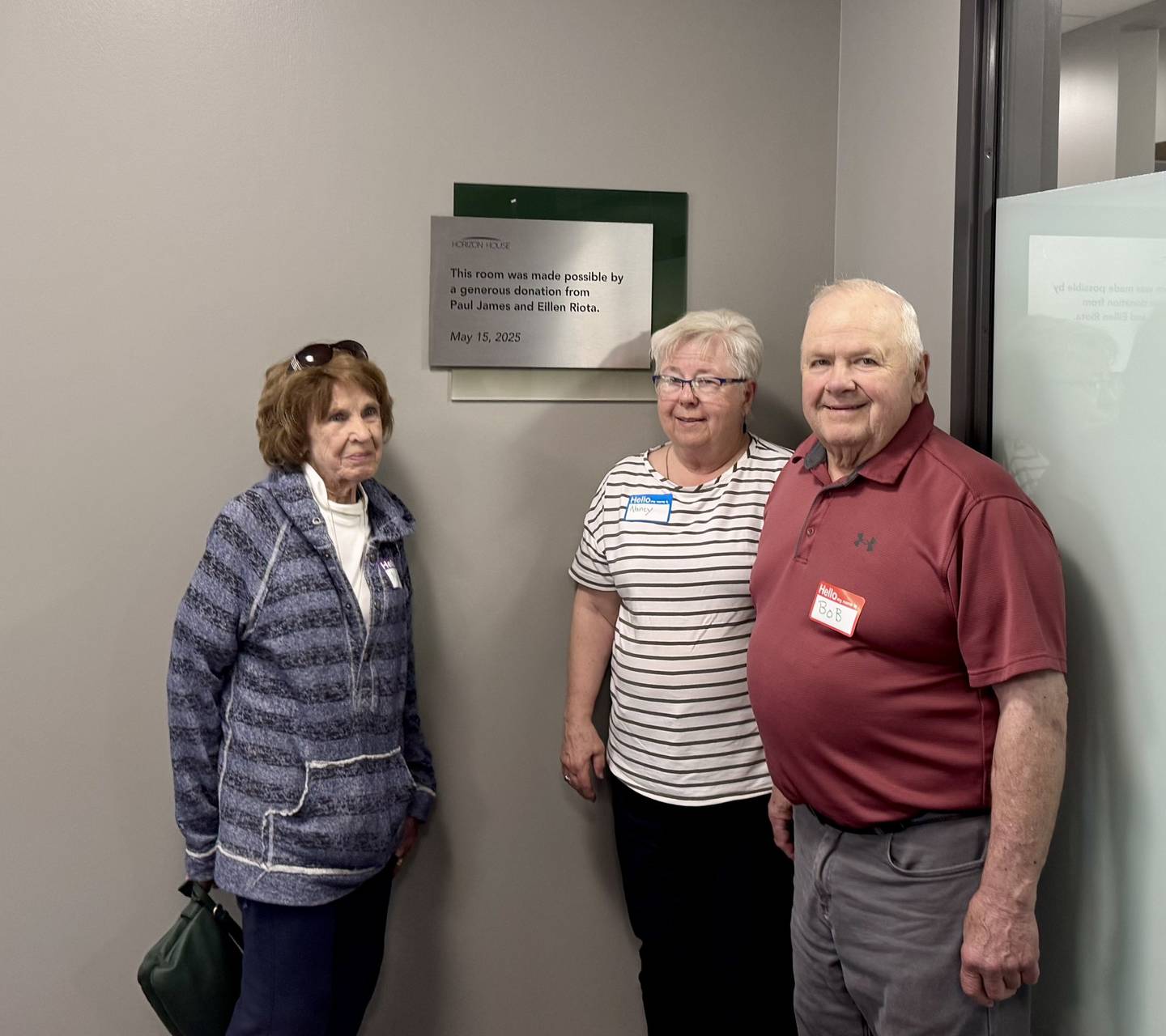 Mary Douvia, Nancy and Bob Rogawski, family members of Paul James and Eileen Riota, stand in the dedication room on May 15,2025 at Horizon House in Peru.