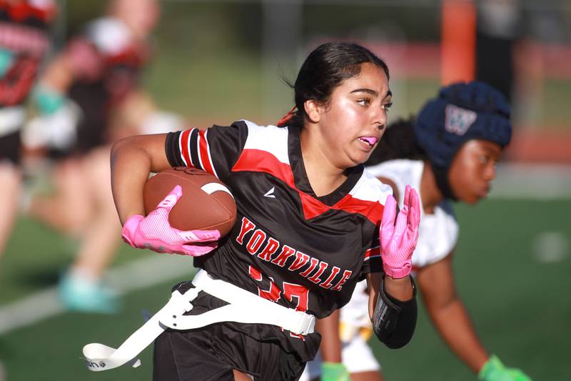 Yorkville’s Bella Esquivel runs with the ball during a flag football game Wednesday, Sept. 4, 2024 against West Aurora in Yorkville.
