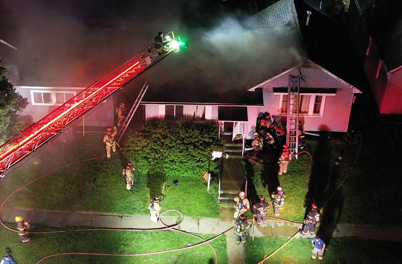 Firefighters work the scene of a structure fire in the 100 block of West Cleveland Street on Thursday, May 15, 2025 in Spring Valley. The fire broke out shortly before 8:30p.m. Fire departments from La Salle Bureau and Putnam Counties responded to the scene. One firefighter was injured at the scene. A mutual aid box alarm system (MABAS) call was issued prompting the response.