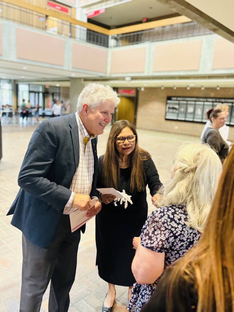 Sauk Valley Community College President Dave Hellmich and Ana Lara greet students June 3, 2025, at the college's adult education graduation ceremony.