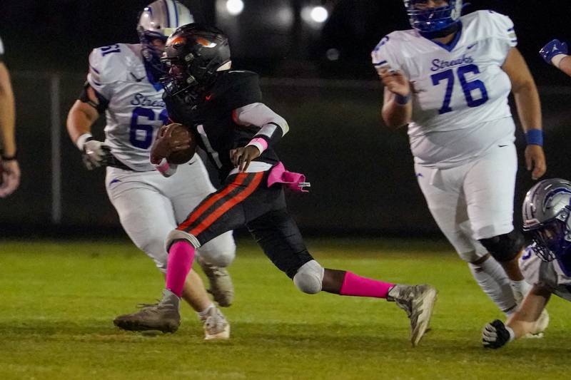 Sandwich's Simeion Harris (1) carries the ball against Woodstock during a football game at Sandwich High School on Friday, Oct. 11, 2024.