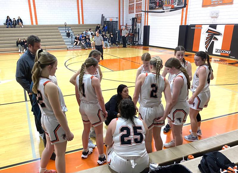 FCW coach Danielle Pollitt (center) talks things over with her Falcons during a fourth-quarter timeout Thursday, Jan. 25, 2024, in Flanagan.
