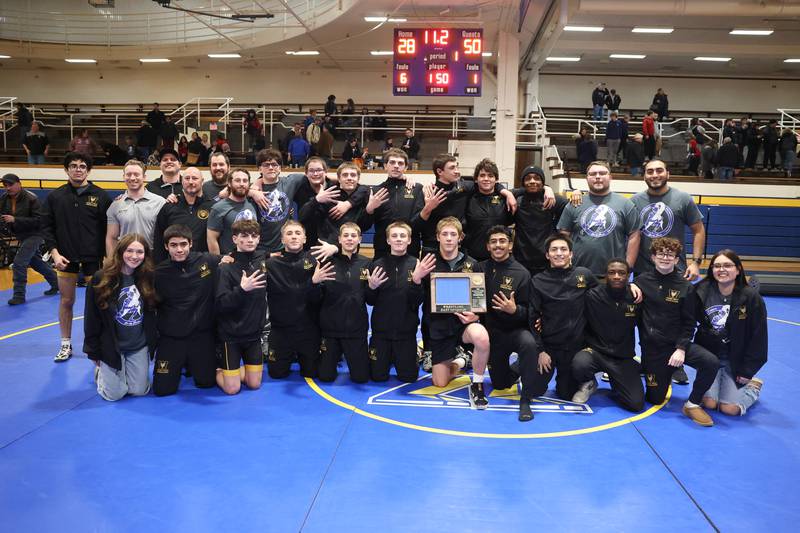Joliet West poses with the conference championship plaque after their win over Joliet Central on Friday, Jan 31, 2025.