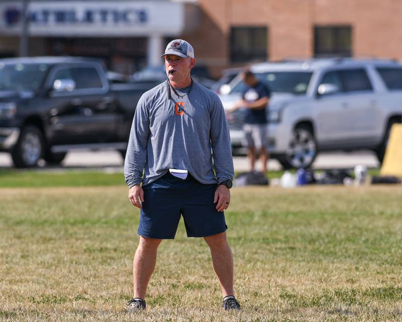 Oswego football head coach Brian Cooney looks on during a joint practice with Kaneland on Thursday July 10, 2025, held at Oswego High School.