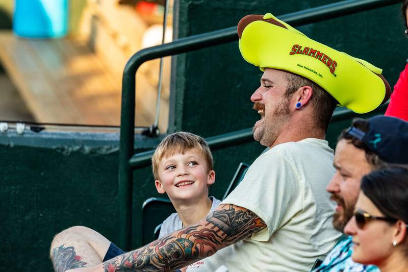 Shane O'Brien, Jr. and Shane O'Brien, Sr., of Channahon enjoy the Joliet Slammers game, which featured the Wiener Drop World Record Attempt, on July 22, 2025.