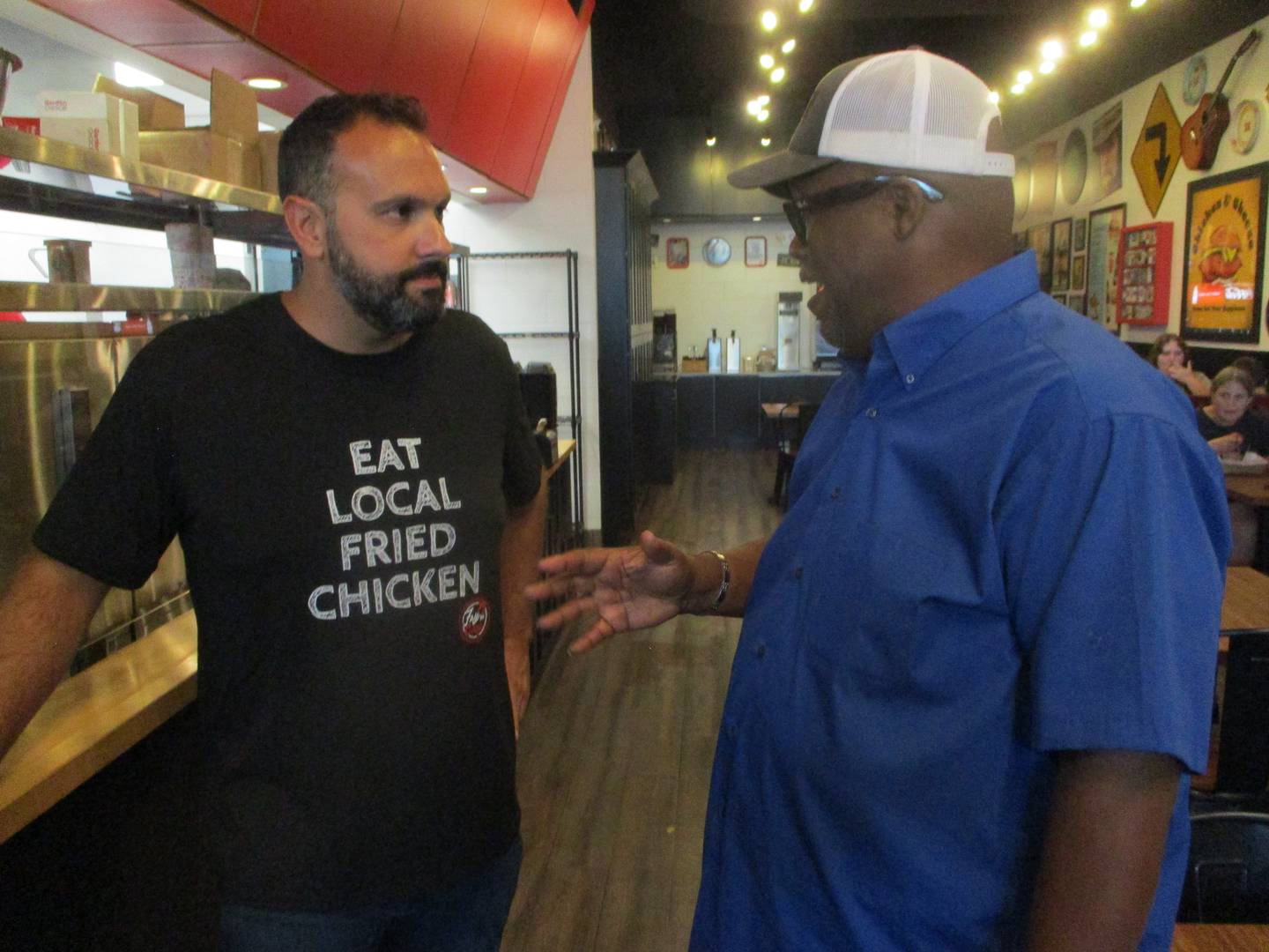 Fry the Coop owner Joe Fontana talks with customer Ken Smith of Joliet during the Joliet restaurant's grand opening on Thursday, Aug. 14, 2025.
