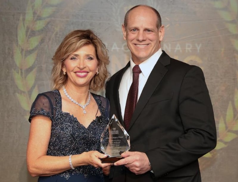 Roxanne Emmerich, founder of The Institute for Extraordinary Banking, presents Sterling Federal's Dean Ahlers with a Banky award for customer service on May 18 in Florida.