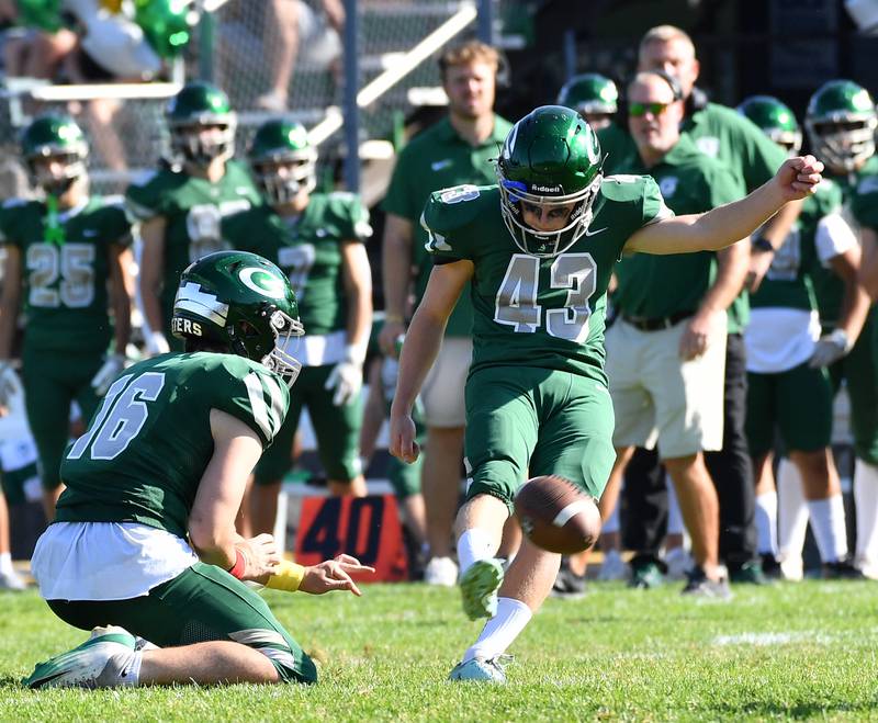 Glenbard West’s Jack Swick (43) kicks a field goal out of the hold of Nathaniel Hickes during a game on September 27, 2025 at Glenbard West High School in Glen Ellyn.