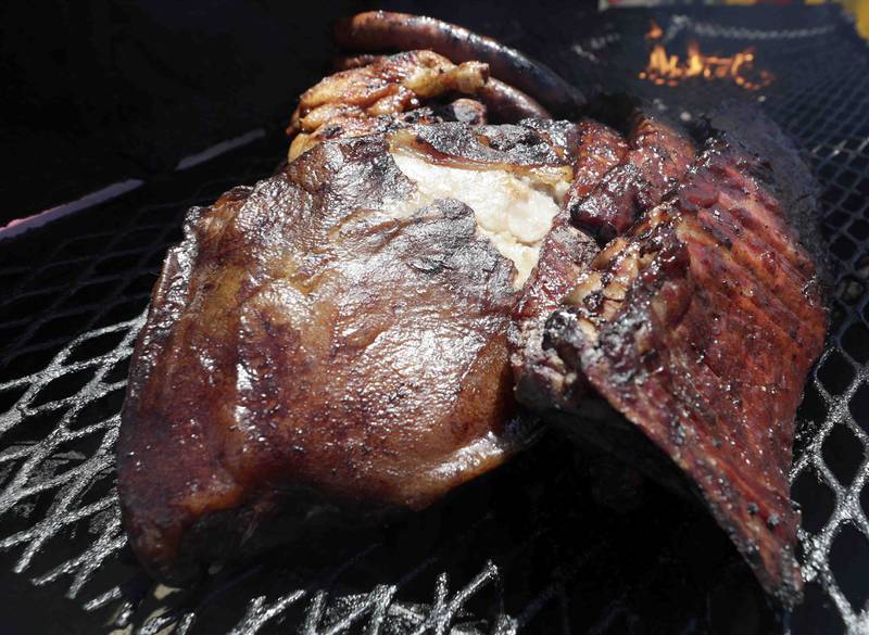 Ribs and other goodies sit ready on the grill for customers during opening day of Ribfest Friday June 17, 2022 at the DuPage County Fairgrounds in Wheaton.