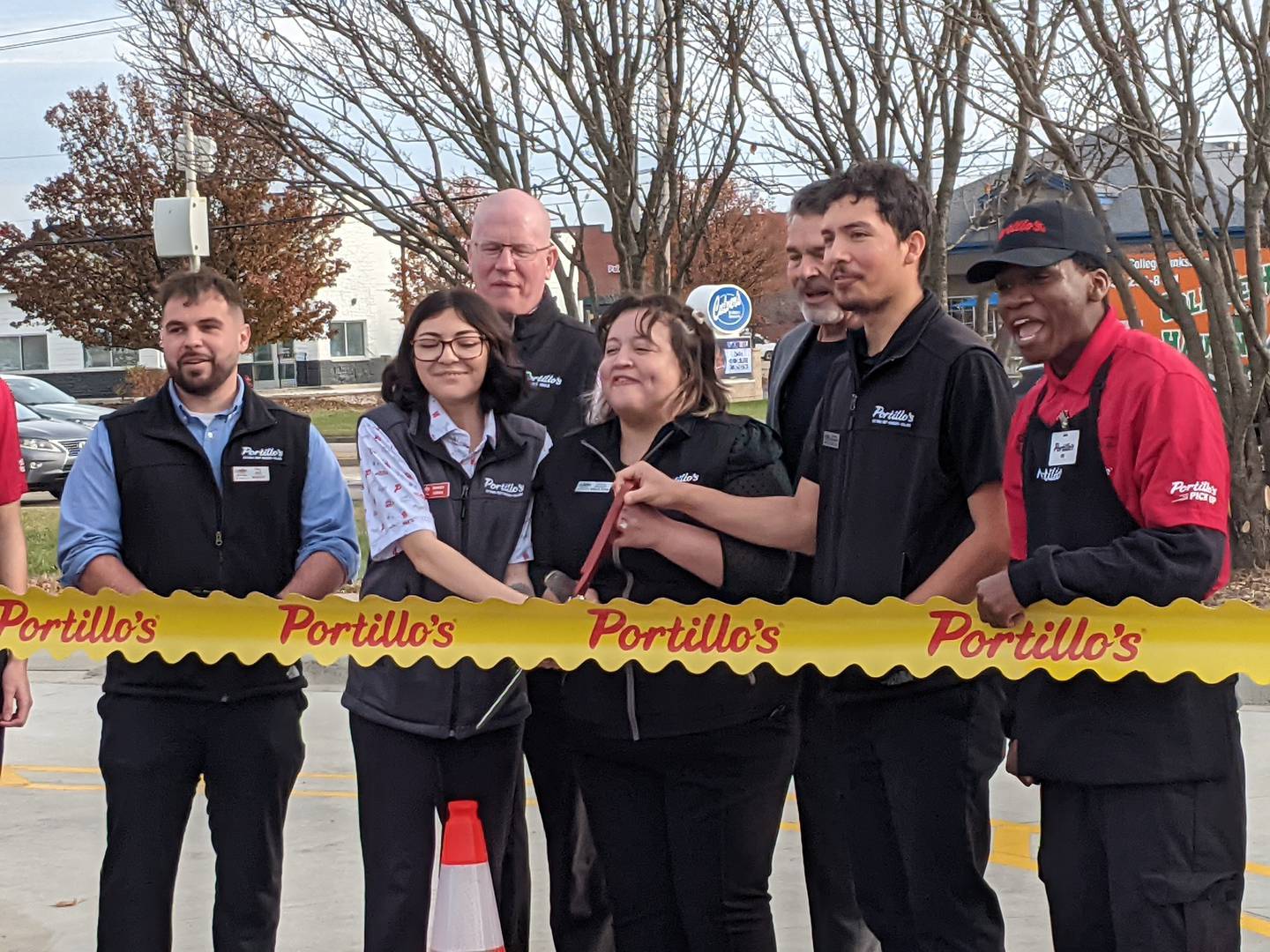 Staff members cut the ribbon during a ceremony at the newly-opened drive-thru only Portillo's restaurant in Plainfield on Nov. 24, 2025.