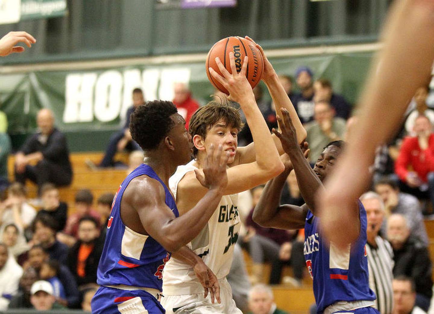 Glenbard West's Braden Huff squeezes between a pair of Glenbard South defenders during a District 87 Thanksgiving Tournament game on Nov. 25 2019 at Glenbard West.