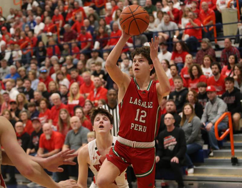 L-P's Michael Hartman cuts around Metamora's Matthew Zobrist to eye the hoop during the Class 3A Sectional on Tuesday, Feb. 27, 2024 at Pontiac High School.