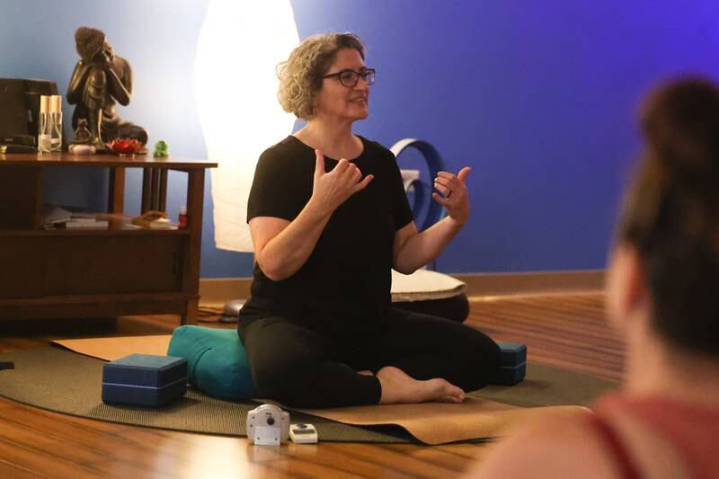 Yoga instructor Mindy Minaeri uses sign language to lead a class deaf students at Just Breathe Yoga Studio on Friday, Oct. 13, 2023 in Crest Hill.