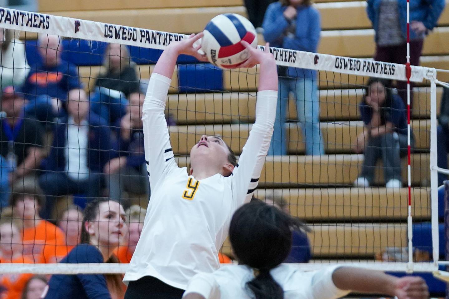 Joliet West's Julia Adams (9) back sets the ball during a volleyball match against Oswego at Oswego High School on Thursday, October 24, 2024.