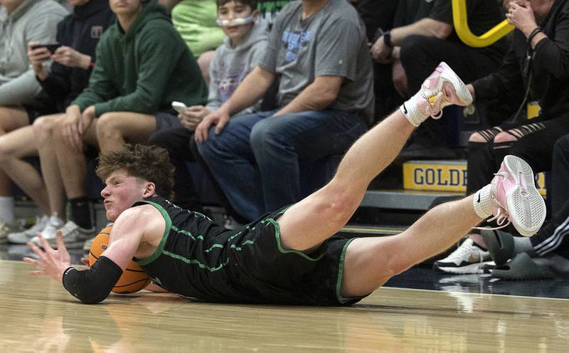 Rock Falls’ Ryken Howard dives for a loose ball against Christ the King Monday, March 10, 2025, during the Class 2A boys basketball Supersectional in Sterling.