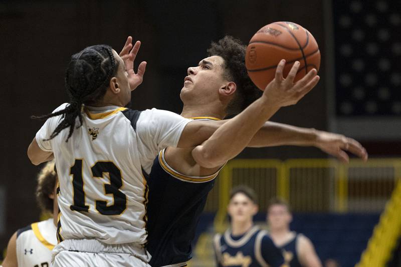 Sterling’s Andre Klaver is fouled by Hinsdale South’s Elijah Fields Monday, Jan. 16, 2023 at the Sterling MLK basketball tournament.