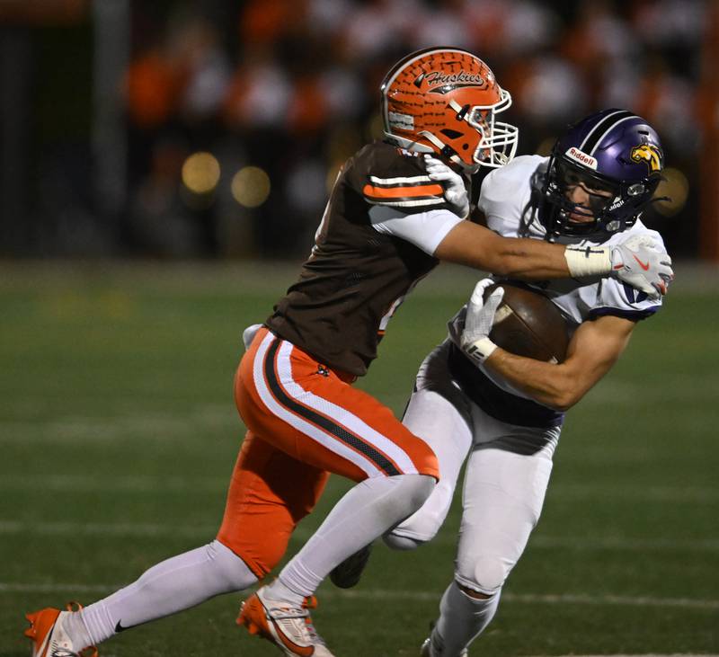 Rolling Meadows’ Matt Sansonetti, right, gets tackled by Hersey’s Luke Casey during a football game on Friday, Oct. 18, 2024 in Arlington Heights.
