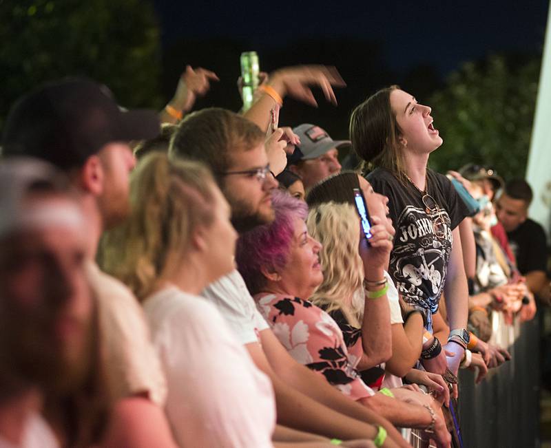 Music fans celebrate Friday night headliner Travis Denning July 1, 2022 at Dixon’s Petunia Fest. Lots more music to be heard on Saturday and Sunday at the festival.