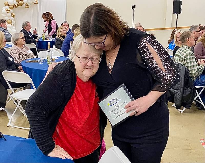An emotional Dilene Simmons (left), embraces Krissy Johnson, executive director of the Genoa Area Chamber of Commerce, after being named the 2024 Community Pride Award recipient on Thursday, Feb. 13, 2025, at the chamber's 68th Annual Meeting and Awards Dinner at Custom Aluminum Products, 312 Eureka St., Genoa.