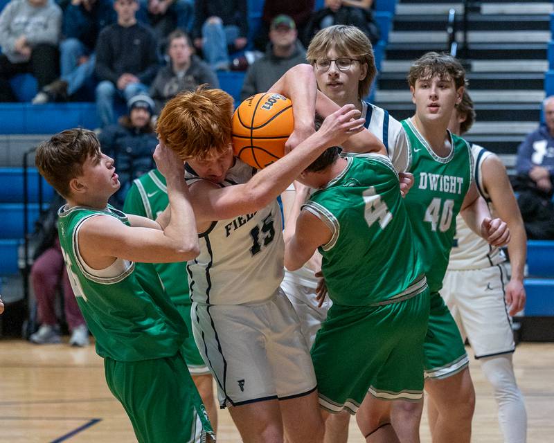 Ethan Vallazza (15) of Fieldcrest fights over rebound with Jack Statler (4) of Dwight on Monday, December 15, 2025 at Fieldcrest High School in Minonk.