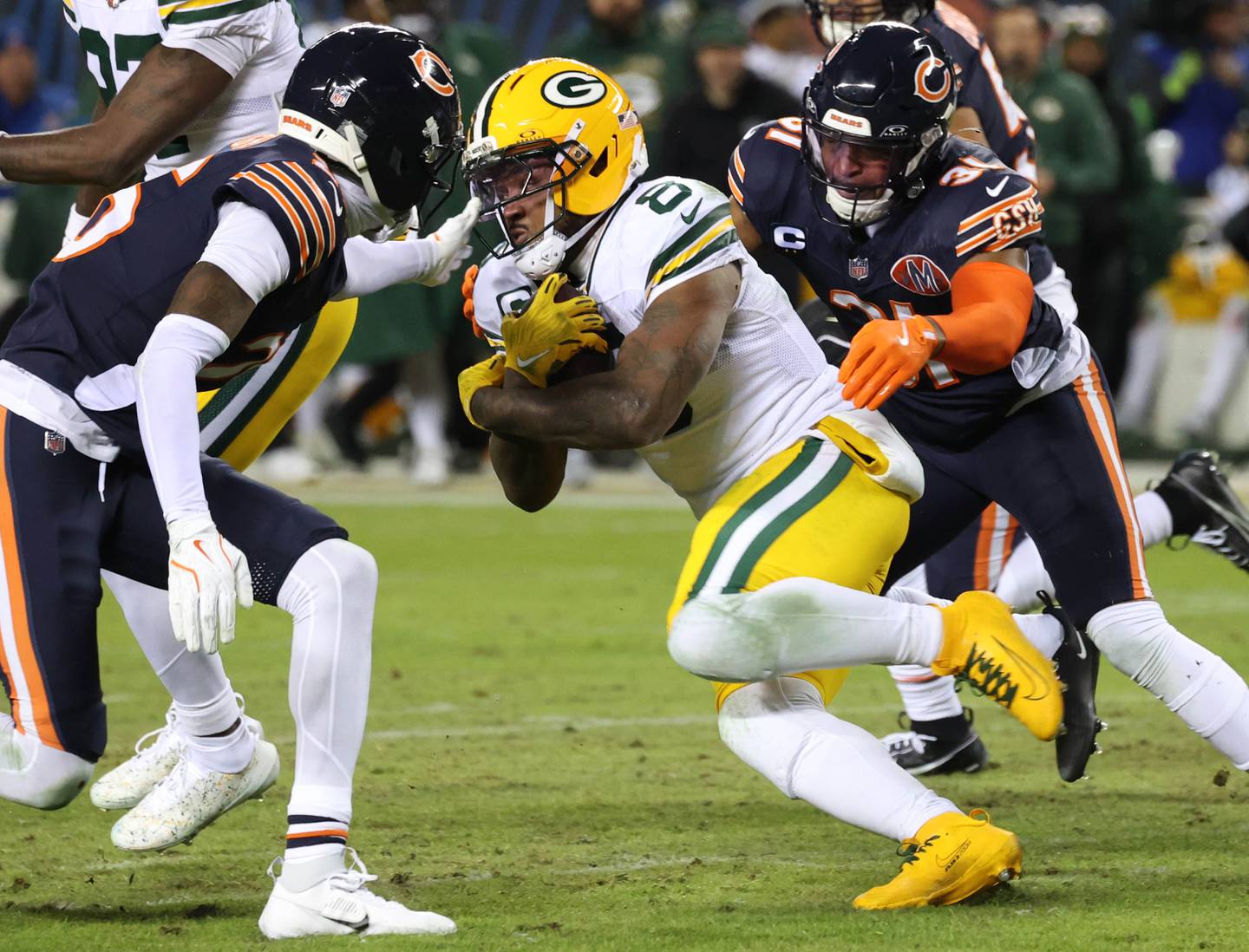 Chicago Bears cornerback Nahshon Wright (left) and safety Kevin Byard III close in on Green Bay Packers running back Josh Jacobs during their NFL Wild Card game Saturday, Jan. 10, 2026, at Soldier Field in Chicago.