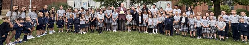 St. Mary's Catholic School students and Ken Andersen installing the Bess Andersen memorial plaque