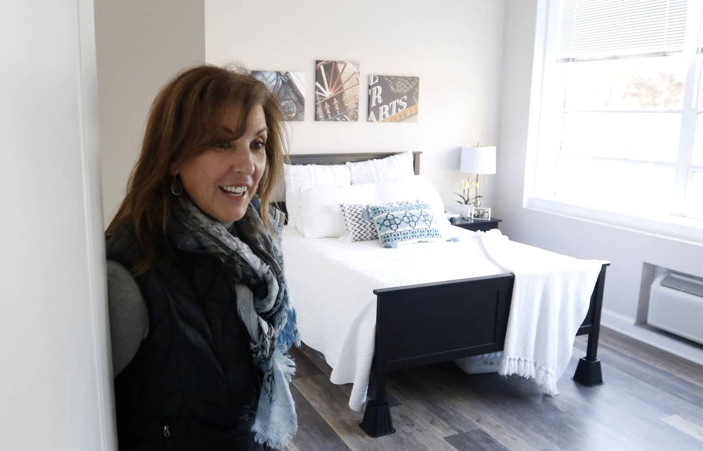 Church Street Apartments tenant Kathy Cheesebro talks Friday, Nov. 5, 2021, about her one-bedroom apartment inside the newly redesigned apartment building, converted from the former Faith Lutheran High School and Immanuel Lutheran Church in Crystal Lake.