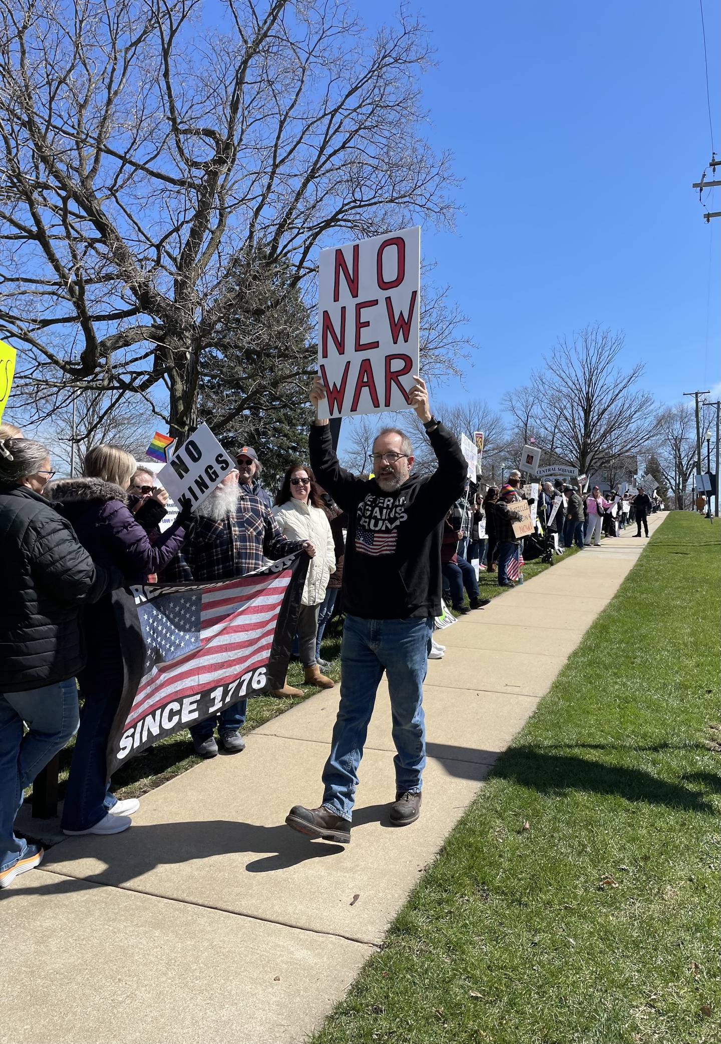 A protester holds up a sign against the war in Iran at the No Kings rally at City Square in Lockport on Saturday, March 28, 2026.