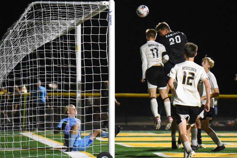 Herscher's Gabriel Kelly, left, looks on as Tigers teammate Connor Buckley (17) and Coal City's Martin Ramirez look to head his deflected save during a game at Coal City Thursday, Oct. 2, 2025.