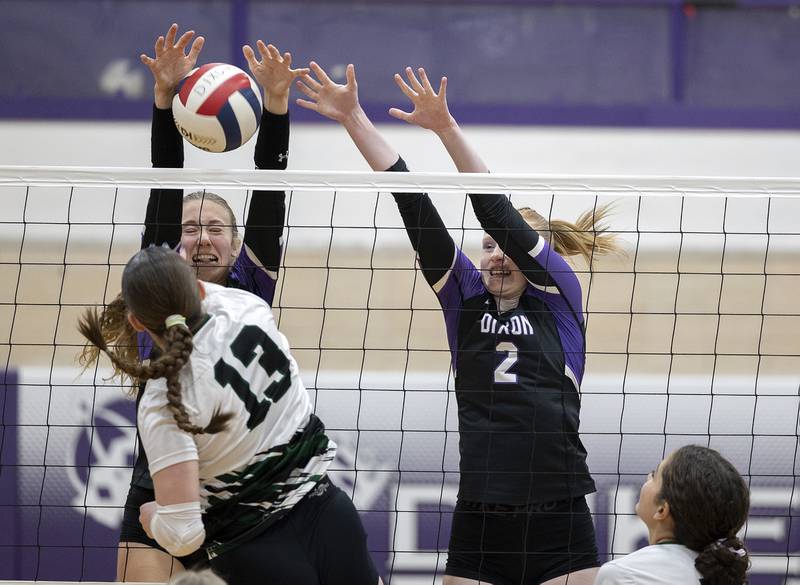 Dixon’s Leah Carlson (left) and Madyson Tichler work the net against North Boone Tuesday, Sept. 24, 2024, in Dixon.