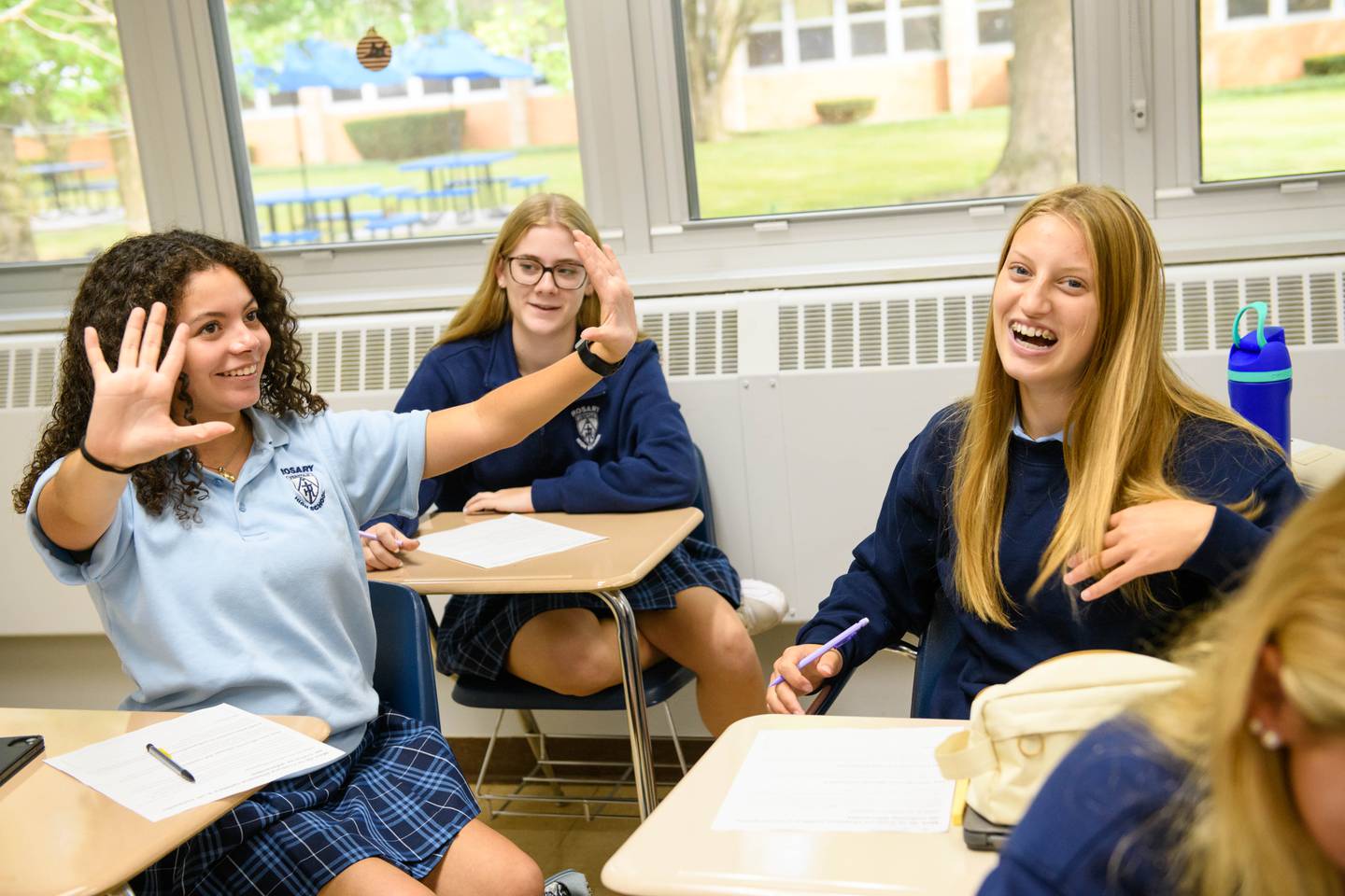Rosary High School juniors Abby Mendez of Aurora (left),  has a laugh with Madalyn Sperlakis and Zoe Rowe both of Yorkville. The all-girls Catholic school in Aurora will take on a new name as of July 1, 2025, Rosary College Prep.