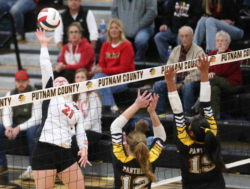 Henry-Senachwine's Brynna Anderson smacks a kill past Putnam County's Chloe Parcher and teammate Britney Trinidad during the Class 1A Regional semifinal game on Wednesday, Oct. 29, 2025 at Putnam County High School.