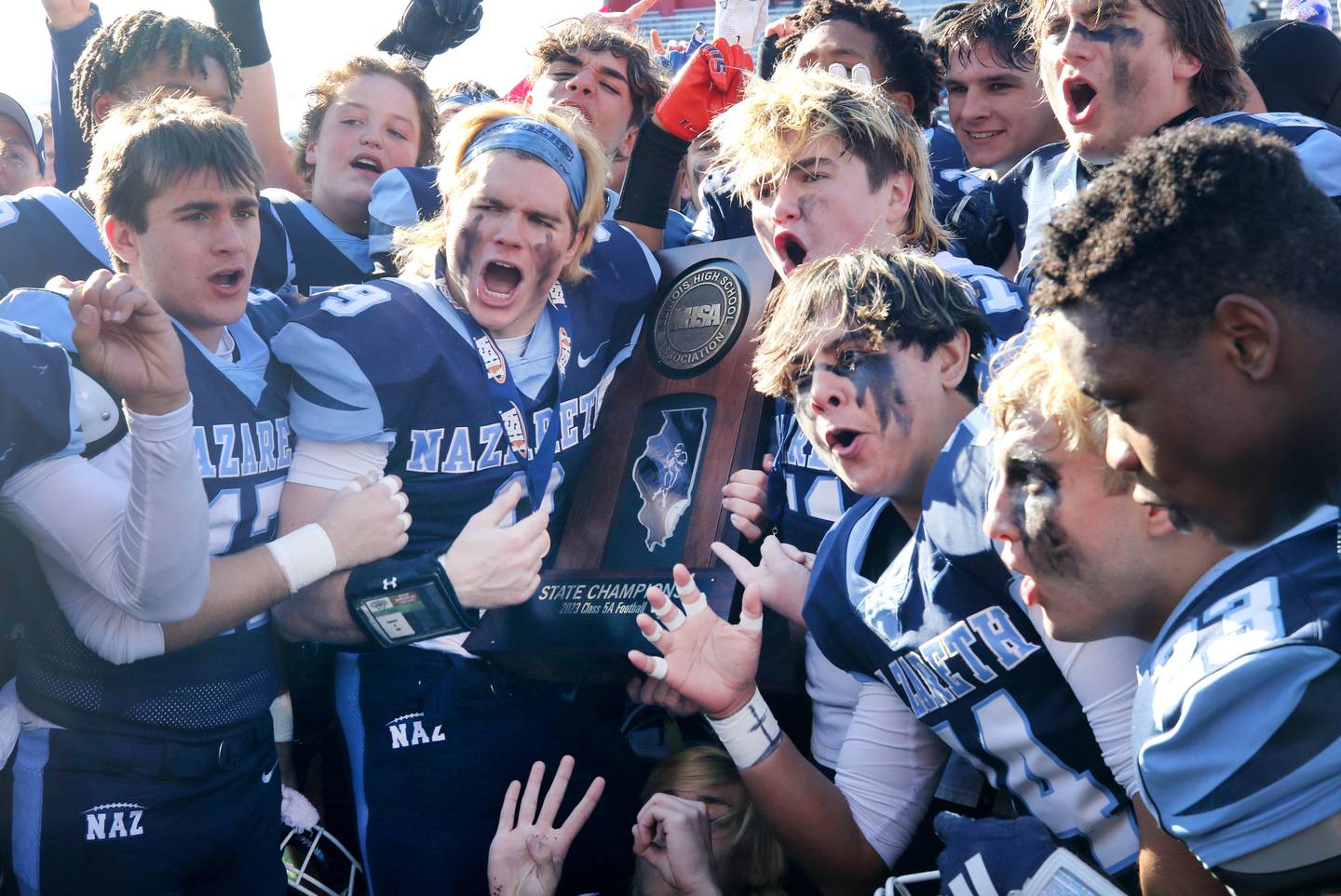 Nazareth celebrates with the trophy in November 2023 after their IHSA Class 5A state championship win over Joliet Catholic at Hancock Stadium at Illinois State University in Normal.