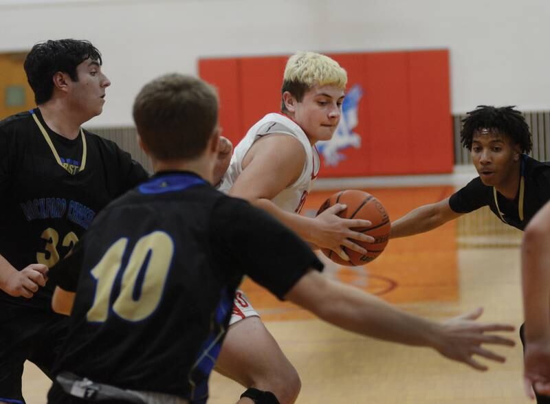 Oregon's Cade Girton (34) is surrounded by Rockford Christian defenders during the third place game at the Oregon Thanksgiving Tournament on Saturday, Nov. 25, 2023 in Oregon.