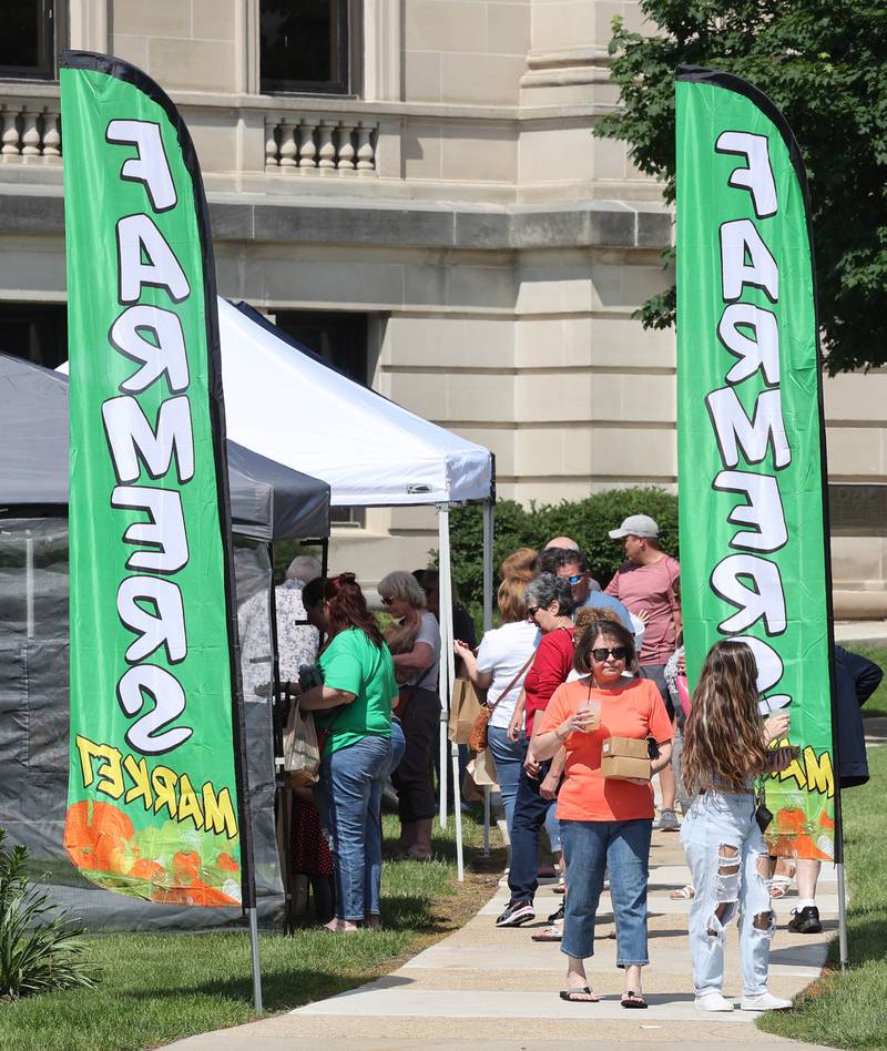 Patrons visit the Sycamore Farmers Market Tuesday, June 7, 2022, at its new location on the lawn of the DeKalb County Courthouse.