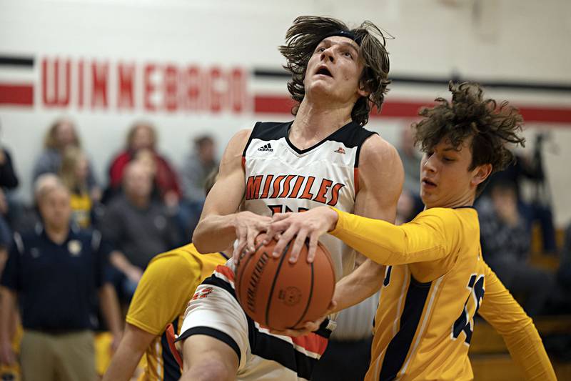 Milledgeville’s Kacen Johnson is fouled by Polo’s Carter Merdian Monday, Dec. 19, 2022 in the Forreston Holiday Tournament.