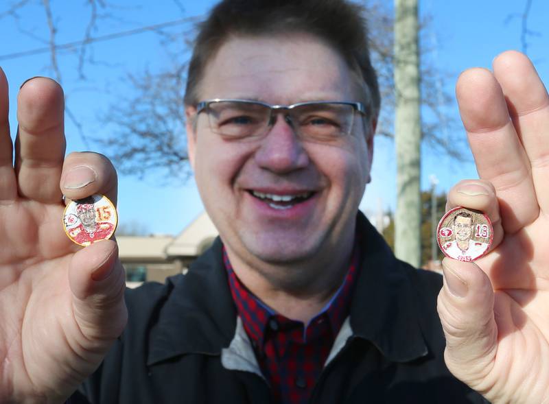 Artist John Kettman of La Salle, holds quarters that he painted of Patrick Mahomes and Brock Purdy on Feb. 9, 2024. Kettman paints the back of the quarters representing the quarterback.