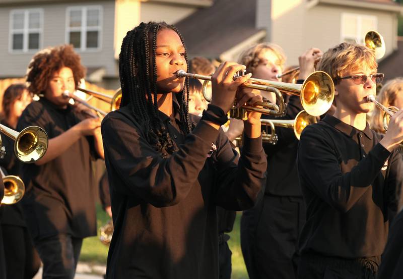 Members of the Huntley and Clinton Rosette Marching J-Barbs head down Dresser Road Wednesday, Sept. 27, 2023, during the DeKalb High School homecoming parade.