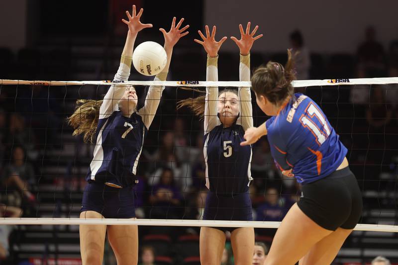 IC Catholic’s Delilah Hyland (7) and Kiely Kemph (5) go for the block against Genoa-Kingston in the Class 2A championship match on Saturday in Normal.