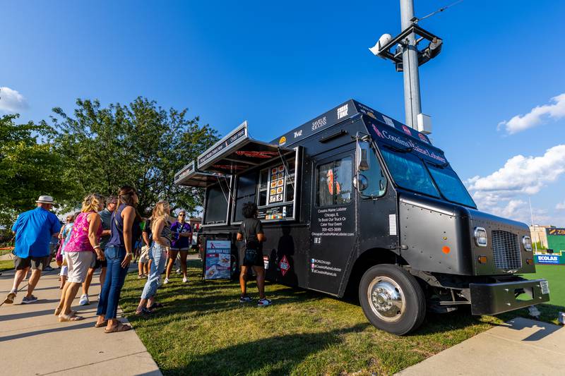New Orleans North Festival attendees wait in line at the Cousins Maine Lobster food truck at the Joliet Slammers Stadium on Aug. 16, 2024.