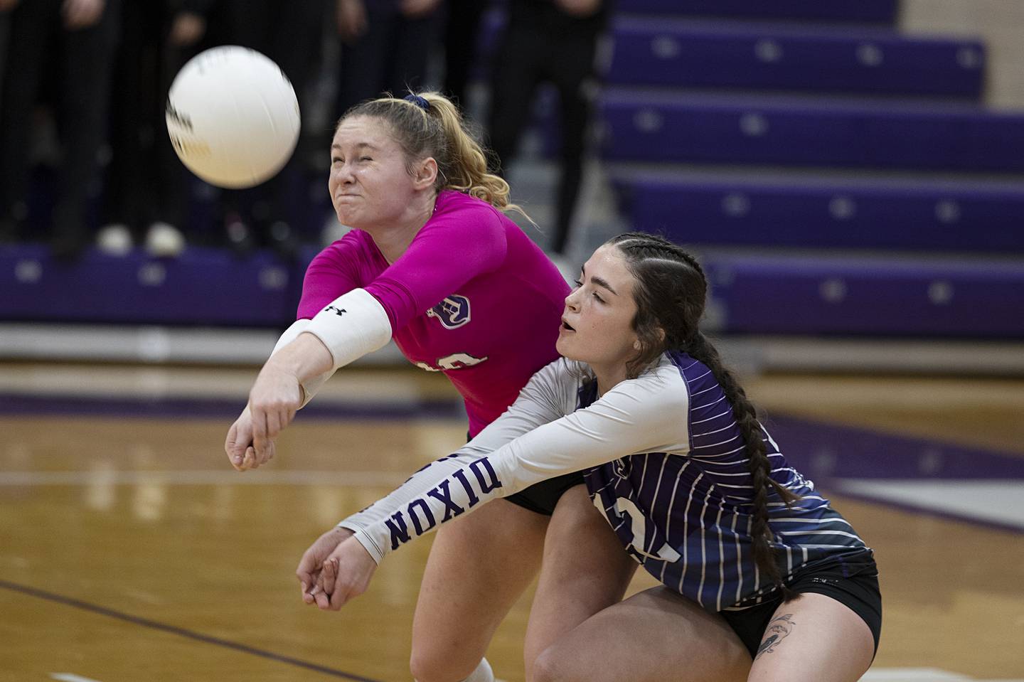 Dixon’s Natalie Davidson (left) and Joey Brumbly come together to play a ball Thursday, Oct. 27, 2022 in the volleyball regional final against Galesburg.