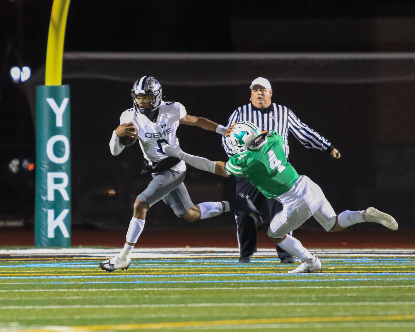 Oswego East's Robert Tyre Jones III (9) scrambles away from York's Evan Grazzini (4) during Class 8A Playoff football game between Oswego East at York.  Oct 28, 2022.